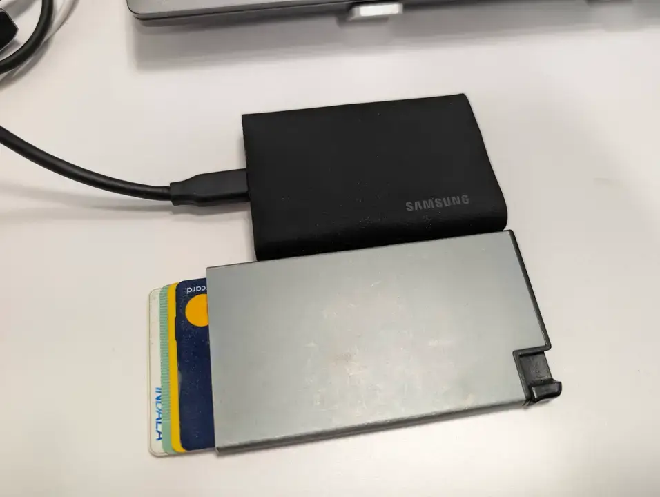 The Samsung T9 SSD drive size compared to a credit card displaying the slim and compact portable design.