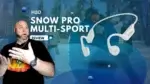 A man looking at the H2O Snow Pro bone conduction headphones with a surprised look.