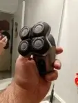 Philips Head Shaver Pro 9000 Series Review 2025: Is It Really the Smartest Bald Shaver Yet? | Smart Tech, Sharp Takes - CRYOVEX.com Reviewer holding the philips head shaver pro 9000 series showing its ergonomic palm grip.