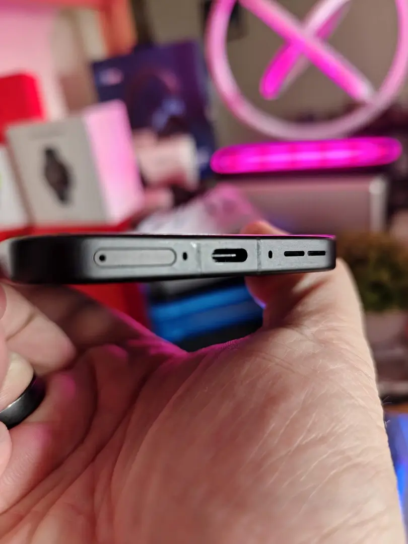 OnePlus 15 Canadian Review: The Powerful Flagship Killer Canadians Can Finally Get Their Hands On | Smart Tech, Sharp Takes - CRYOVEX.com Bottom edge of the oneplus 15 showing the usb-c port, speaker grille, sim tray, and microphone openings