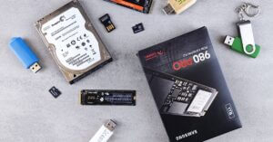 CXMT Sets Sights on NAND Flash, Targeting Samsung and YMTC | Smart Tech, Sharp Takes - CRYOVEX.com Flat lay of various computer data storage devices on a gray surface.