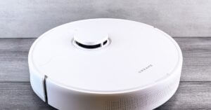Ecovacs X12S OmniCyclone brings hands-off cleaning to Canada | Smart Tech, Sharp Takes - CRYOVEX.com Sleek white robot vacuum cleaner on a wooden floor, perfect for smart home setups.