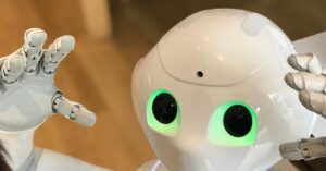 Microsoft Exec Labels AI Training the Largest Theft of Labor in History | Smart Tech, Sharp Takes - CRYOVEX.com A futuristic humanoid robot with glowing green eyes in a modern setting.