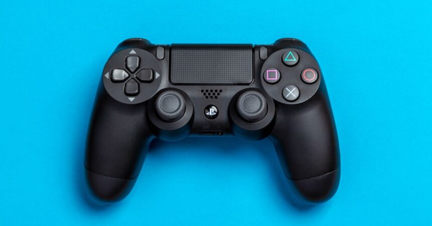 PlayStation game‑sharing meme gets a fresh spin from former Sony execs | Smart Tech, Sharp Takes - CRYOVEX.com Black game controller against a vibrant blue background, perfect for gaming-themed content.