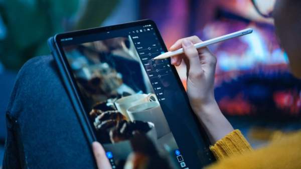 Beyond the Monitor: Why Photographers Are Switching to Tablets for Editing | Smart Tech, Sharp Takes - CRYOVEX.com Photographer using a tablet device for image editing in a studio setting