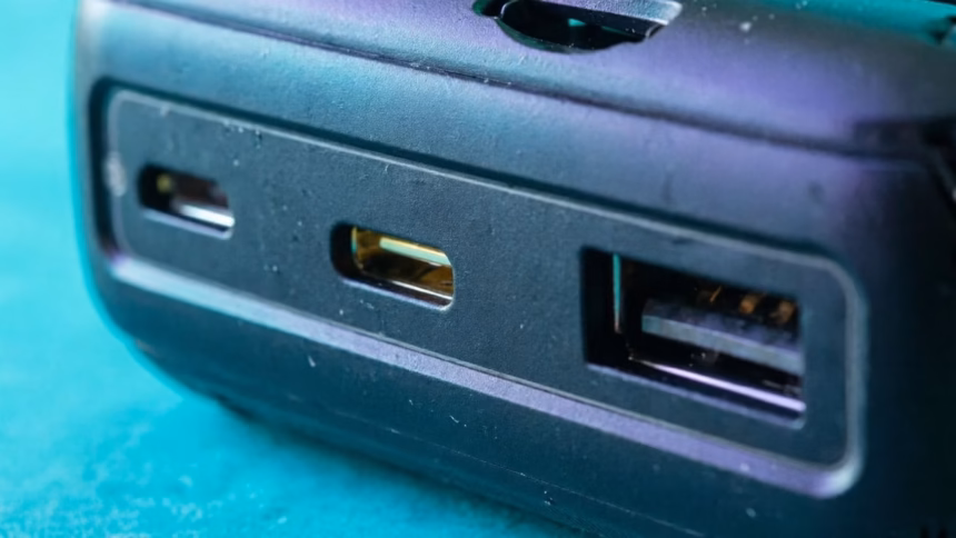Close-up of a laptop side showing multiple usb-c ports with small lightning bolt icons indicating power delivery capabilities.