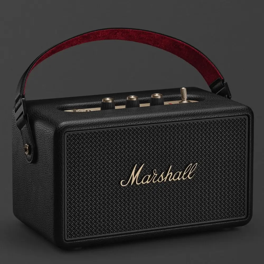 Marshall Kilburn III Review: Incredible Sound, Retro Style | Smart Tech, Sharp Takes - CRYOVEX.com Marshall kilburn iii portable bluetooth speaker in black with a woven front grille, gold marshall logo, top-mounted control knobs, and a red-lined carrying strap.