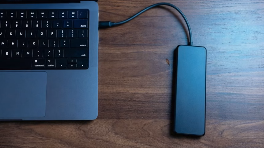 What to Look for in a Portable SSD Amidst Rising Memory Costs | Smart Tech, Sharp Takes - CRYOVEX.com Close-up of a silver portable solid state drive connected via usb cable